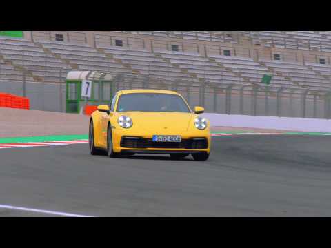 The new Porsche 911 Carrera S in Racing Yellow on the Race Track