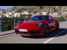 The new Porsche 911 Carrera 4S in Guards Red on the Country Road