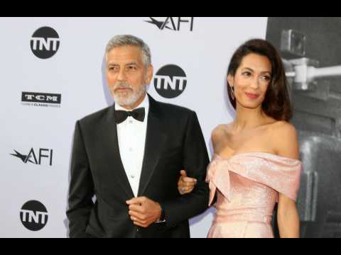George and Amal Clooney donate $100k to migrant charity