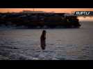 She-Daredevil Swims In Frozen Caspian Sea at Dusk in Just Her Swimsuit