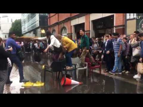British summer strikes again! Londoners make chair bridge to avoid puddle