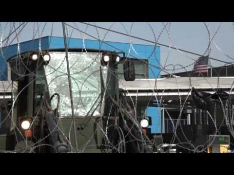 US soldiers add barriers at Mexico border as migrants approach