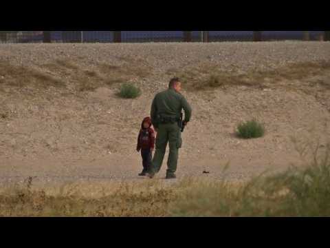 Migrants cross the US-Mexico border and turn themselves in
