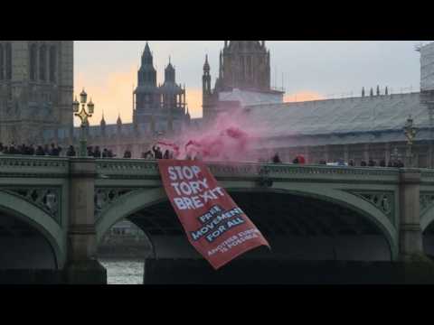 A few protestors unveil anti-Brexit banner near UK Parliament