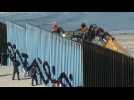 US reinforces border wall in Tijuana as migrants look on