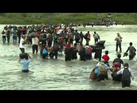 Migrants cross the river at the Guatemala-Mexico border