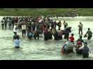 Migrants cross the river at the Guatemala-Mexico border