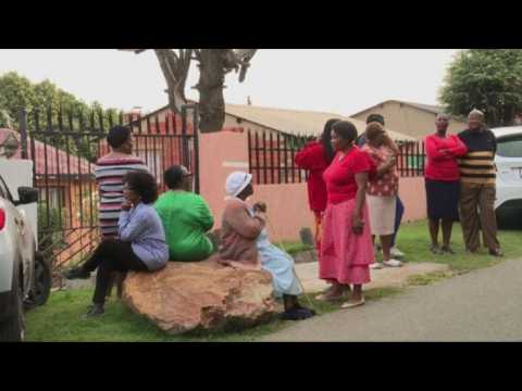 People gather outside Winnie Mandela's home on news of her death