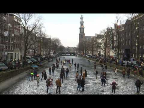Ice skaters enjoy frozen Amsterdam canals