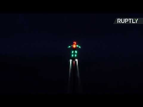 Daredevil Flyboarders Dressed in Glowing Suits Light Up the Sky Over Lake