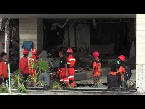 Rescuers search the Mercure Hotel in Palu