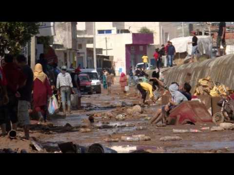 Tunisians wade through the mud following flash floods