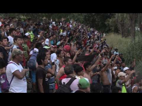 Migrants sing Honduran anthem to caravan stuck on border