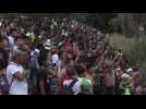 Migrants sing Honduran anthem to caravan stuck on border