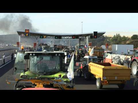 French farmers block motorway toll booth by Montpellier