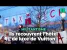 Des militants d'Attac déploient une spectaculaire banderole sur l'hôtel de luxe Vuitton