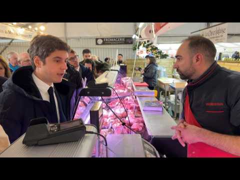 French PM talks with shopkeepers during market visit in Royan