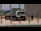 Trucks cross the newly reopened Erez crossing after delivering aid in Gaza