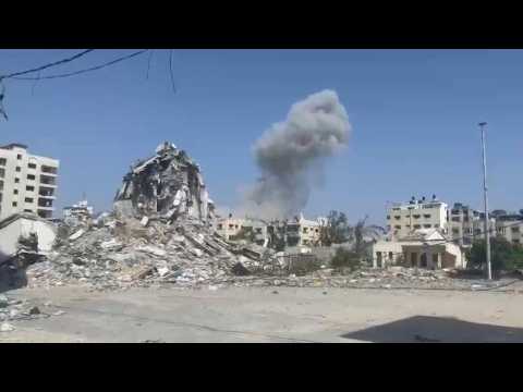 Smoke rises over destroyed buildings in Gaza City