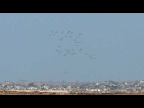 Humanitarian aid parachuted into Gaza by air, seen from Israel