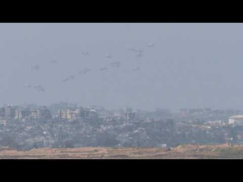 Aid is airdropped over northern Gaza, seen from Israel