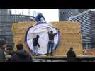 French farmers stack bales of hay by European Parliament in protest