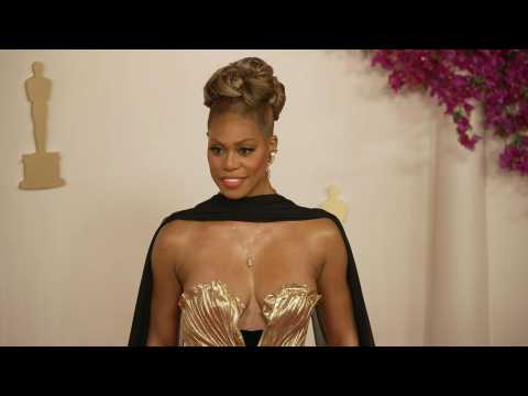 Laverne Cox poses for photographs on the Oscars red carpet
