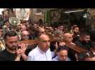 Christians walk down Via Dolorosa during Good Friday Procession