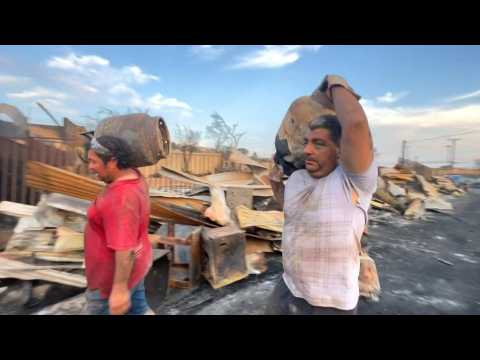 People remove debris left by deadly wildfire in Chile