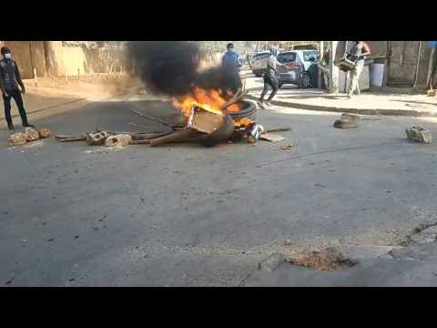 Barricades burn on the streets in Dakar as demonstration broken up