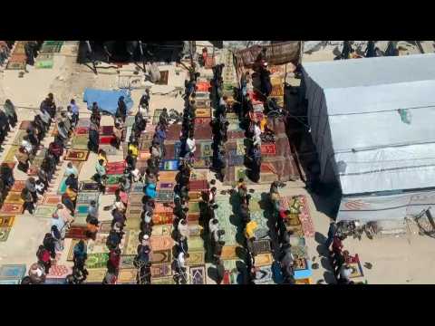 Palestinians perform Friday noon prayers near tent in Rafah