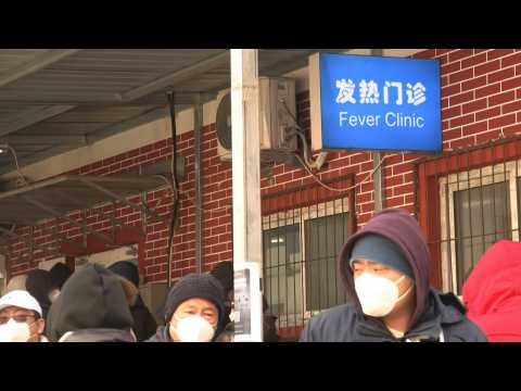 Beijing residents queue outside clinic as infections soar