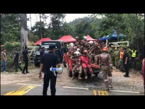 Malaysia: rescue workers at campsite after deadly landslide