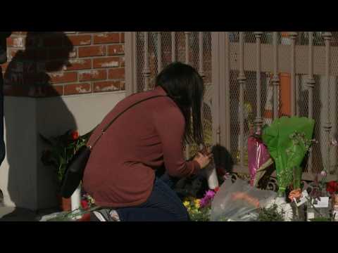 People lay flowers for Monterey Park mass shooting victims at makeshift memorial