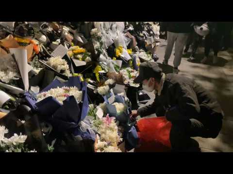 Chinese mourners lay flowers outside Jiang Zemin's former residence
