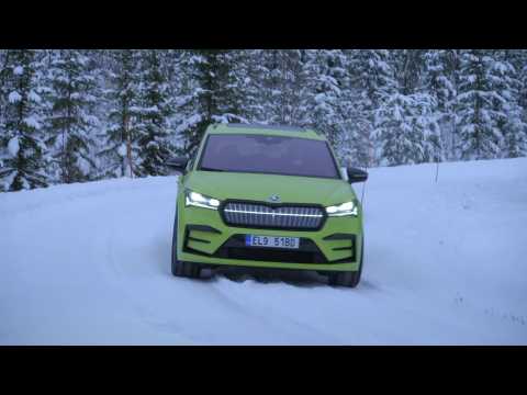 The new Skoda Enyaq RS iV in Mamba Green Driving in the snow