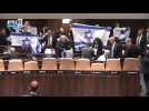 Israeli opposition lawmakers wave flags during Knesset session, get escorted out