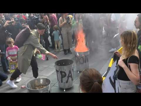 People burn mock bills in UK protest against rising cost of energy