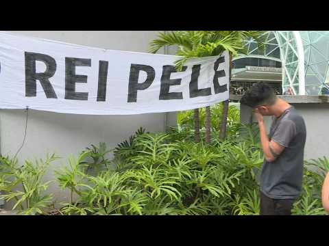 Pele fans mourn his death outside the hospital where Brazil's football legend died