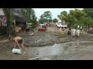 People clean up flooded streets in Sayulita as Hurricane Roslyn hits Mexico
