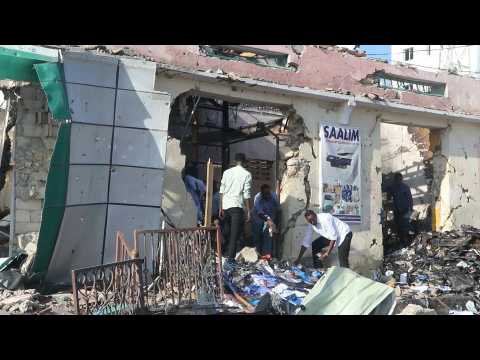 People clear rubble day after twin blasts rock Somali capital