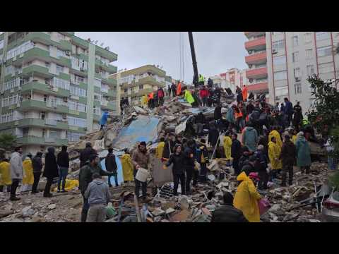 People clear rubble from buildings destroyed by quake in southern Turkey