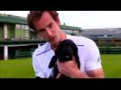 Andy Murray plays with pups