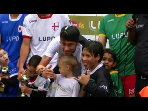Brazil's Neymar helps disabled kids play soccer