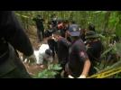 Migrant remains exhumed in Malaysian jungle camp