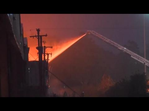 Firefighters battle massive warehouse fire