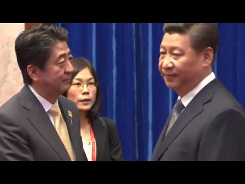 Frosty greeting between Xi and Abe