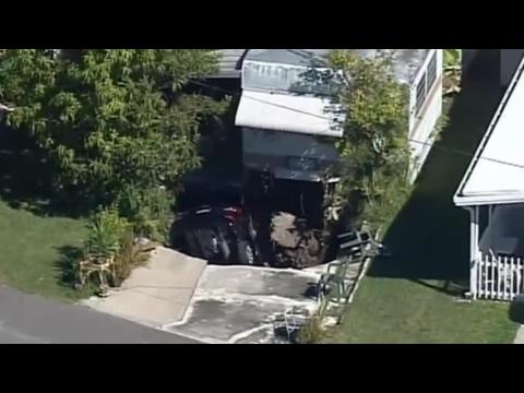 Possible sinkhole swallows car in Florida driveway
