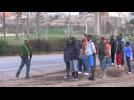 Hundreds of migrants scramble to cross razor wire fence into Spain