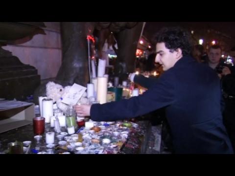 Parisians pay tribute to victims after newspaper attack suspects were killed